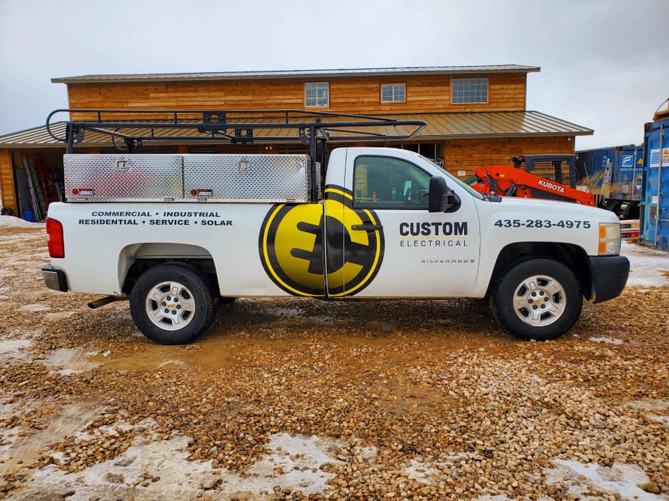 Custom Electrical Services  truck parked outside a new home project - call us today!